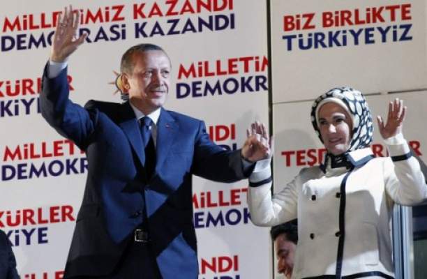 Turkey's Prime Minister Tayyip Erdogan, accompanied by his wife Emine Erdogan, greets his supporters at the AK Party headquarters in Ankara